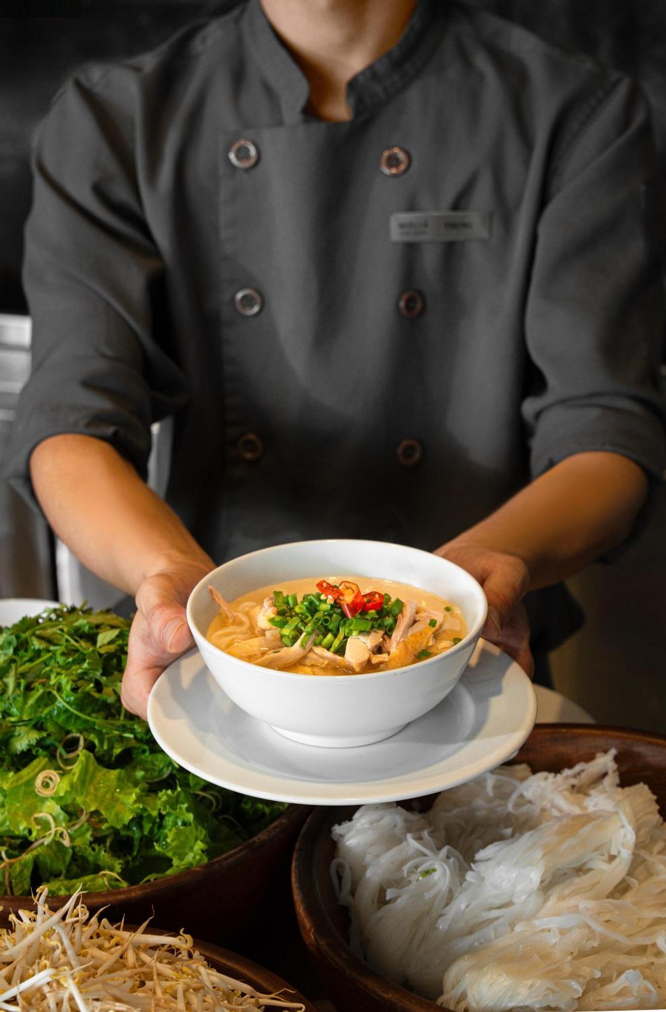 Melia Vinpearl Hue Hotel Екстериор снимка A chef holding a bowl of Tom Kha soup